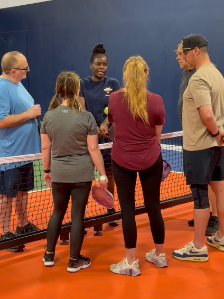 Linda Conrad helping pickleball players improve their skills