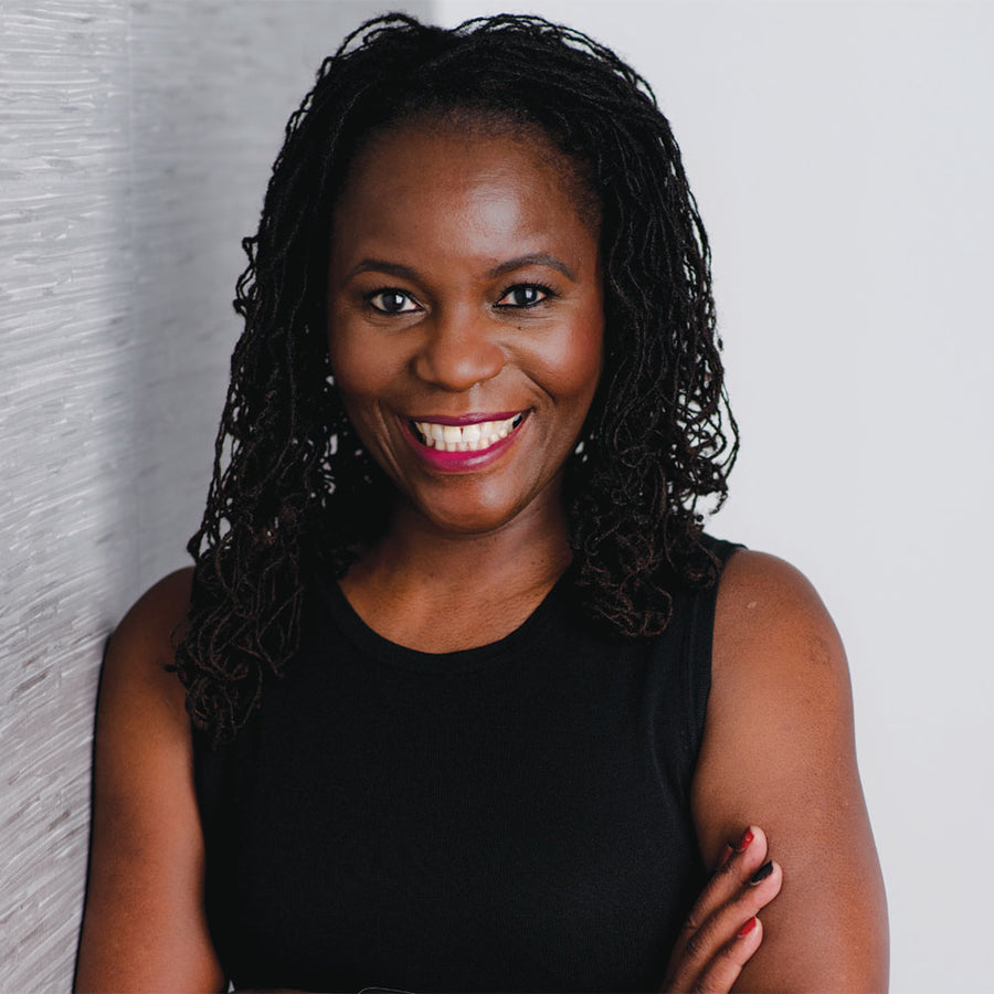 Linda Conrad wearing a red top and smiling for a professional portrait